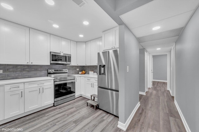 2600 Brookwood Way Dr Unit 111A, Rolling Meadows, IL 60008 - kitchen with appliances with stainless steel finishes, light wood-style flooring, light countertops, white cabinets, and recessed lighting