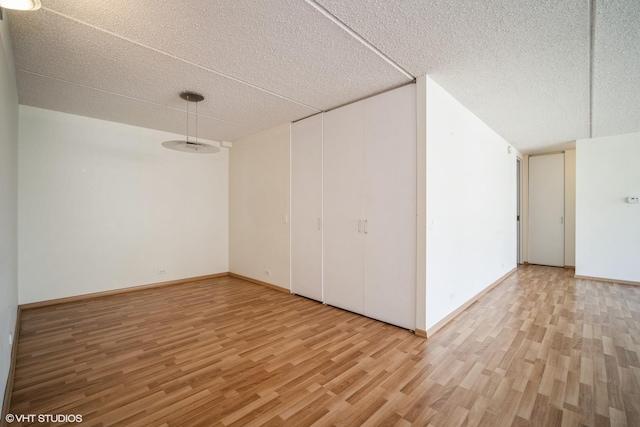 2020 St Johns Ave Unit 309, Highland Park, IL 60035 - additional living space featuring light wood finished floors and a textured ceiling