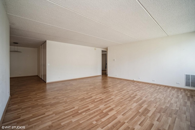 2020 St Johns Ave Unit 309, Highland Park, IL 60035 - unfurnished room featuring light wood-style floors and a textured ceiling