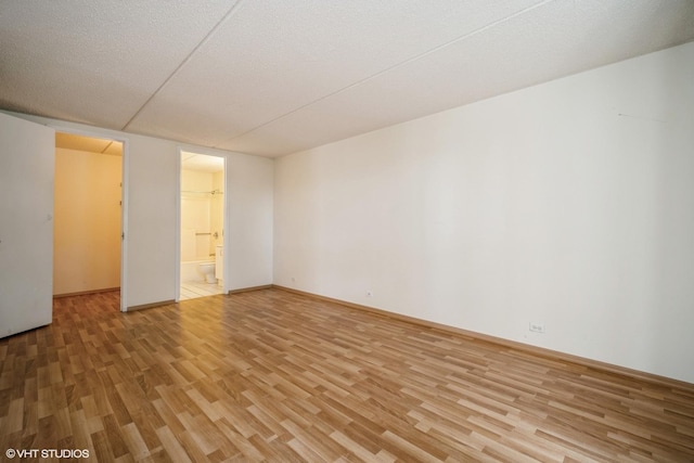 2020 St Johns Ave Unit 309, Highland Park, IL 60035 - spare room with light wood-style floors and a textured ceiling