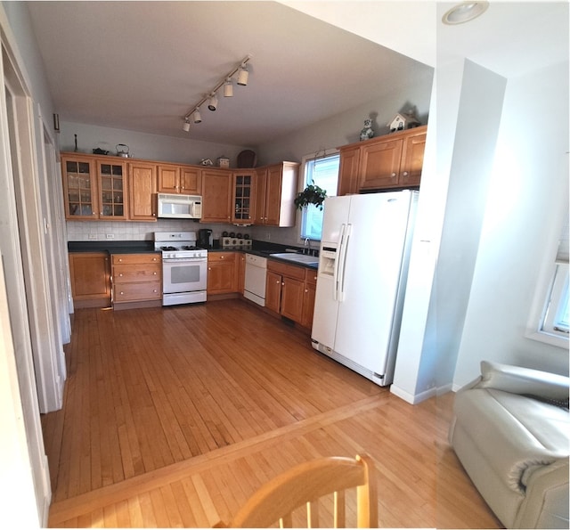 5922 W Dakin St, Chicago, IL 60634 - kitchen with white appliances, dark countertops, and light wood finished floors