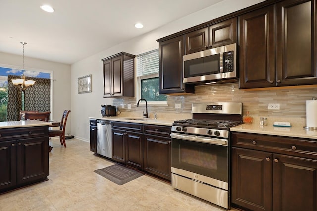 72 Kenneth Ave, Matteson, IL 60443 - kitchen with stainless steel appliances, a chandelier, light countertops, decorative backsplash, and recessed lighting
