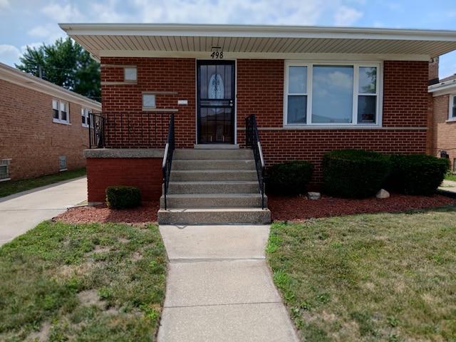 498 Crandon Ave, Calumet City, IL 60409 - bungalow-style house featuring covered porch, brick siding, and a front lawn