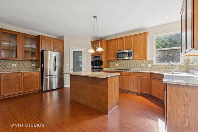 805 W Mystic Ln, Romeoville, IL 60446 - kitchen featuring stainless steel appliances, dark wood-type flooring, decorative backsplash, and brown cabinetry