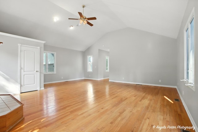 1803 N Woodlawn Park Ave, Mchenry, IL 60051 - unfurnished living room featuring ceiling fan, vaulted ceiling, and light wood-type flooring