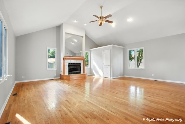 1803 N Woodlawn Park Ave, Mchenry, IL 60051 - unfurnished living room featuring a ceiling fan, a tiled fireplace, light wood-style floors, high vaulted ceiling, and recessed lighting