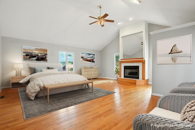 1803 N Woodlawn Park Ave, Mchenry, IL 60051 - bedroom with a tile fireplace, light wood finished floors, high vaulted ceiling, a ceiling fan, and recessed lighting