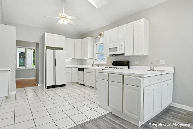 1803 N Woodlawn Park Ave, Mchenry, IL 60051 - kitchen featuring white appliances, lofted ceiling, a ceiling fan, light countertops, and white cabinetry