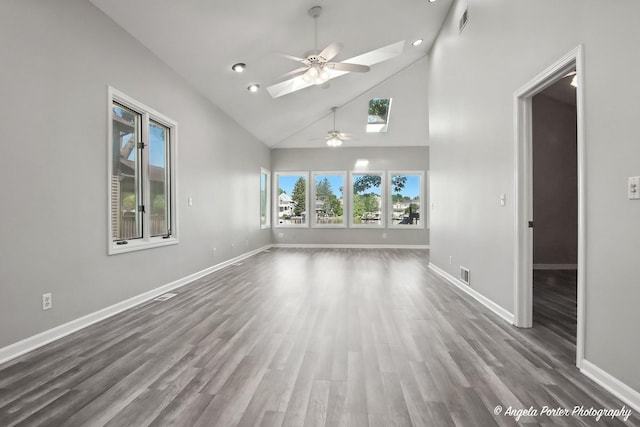 1803 N Woodlawn Park Ave, Mchenry, IL 60051 - unfurnished room with ceiling fan, a skylight, high vaulted ceiling, wood finished floors, and recessed lighting