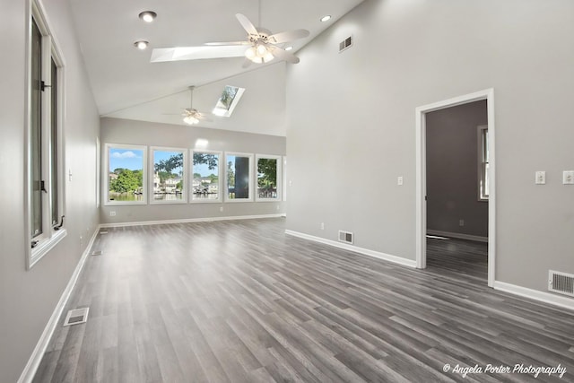 1803 N Woodlawn Park Ave, Mchenry, IL 60051 - unfurnished living room featuring a ceiling fan, a skylight, high vaulted ceiling, wood finished floors, and recessed lighting