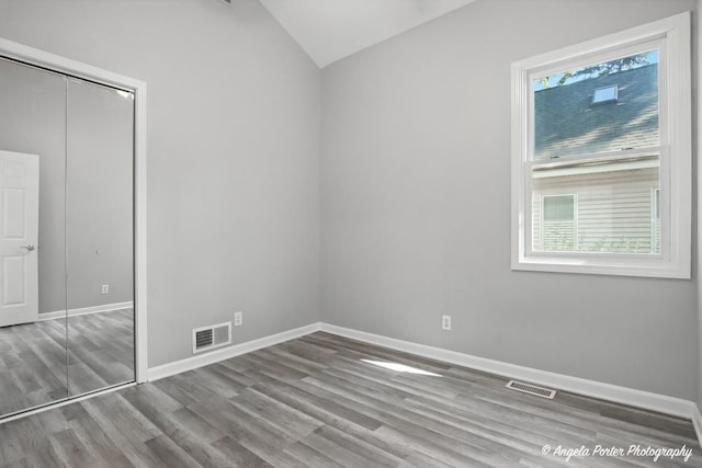 1803 N Woodlawn Park Ave, Mchenry, IL 60051 - unfurnished bedroom featuring lofted ceiling, wood finished floors, and a closet