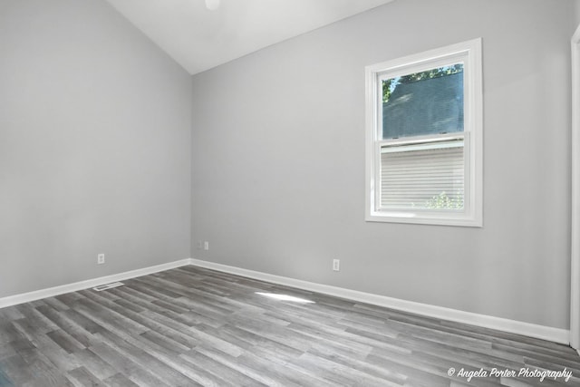 1803 N Woodlawn Park Ave, Mchenry, IL 60051 - empty room featuring vaulted ceiling and wood finished floors