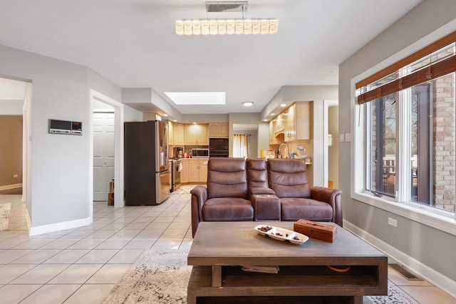 5932 W 75th Pl, Burbank, IL 60459 - living area with light tile patterned floors and a skylight