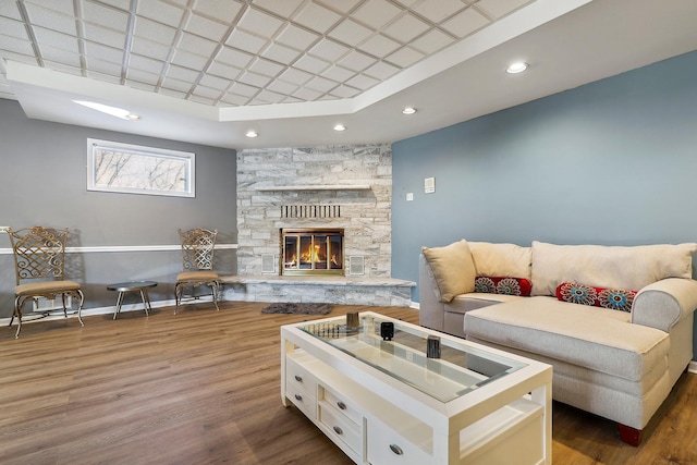 5932 W 75th Pl, Burbank, IL 60459 - living room featuring wood finished floors, a stone fireplace, recessed lighting, and a raised ceiling