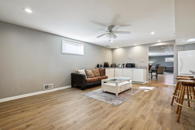 5932 W 75th Pl, Burbank, IL 60459 - living room with light wood-style floors, ceiling fan, and recessed lighting