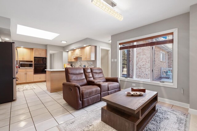 5932 W 75th Pl, Burbank, IL 60459 - living room featuring light tile patterned floors and a skylight