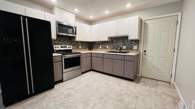 113 E Seminole St, Dwight, IL 60420 - kitchen with stainless steel appliances, light countertops, white cabinetry, tasteful backsplash, and gray cabinets