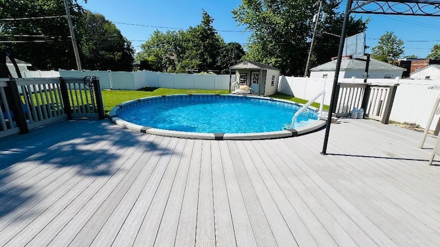113 E Seminole St, Dwight, IL 60420 - view of swimming pool featuring a wooden deck, a fenced backyard, and a storage unit