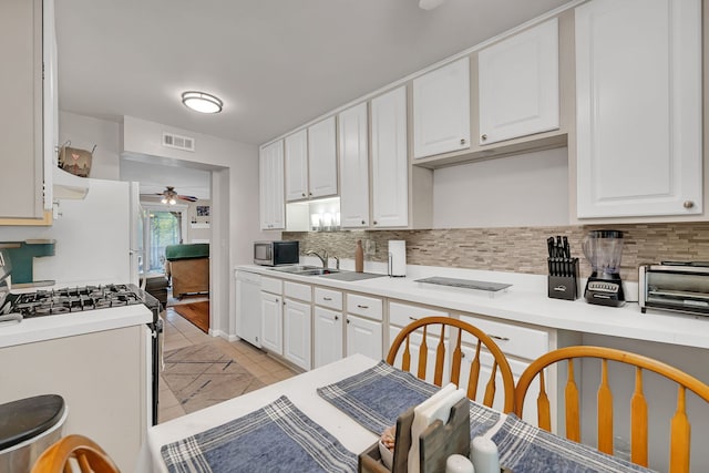 2003 Tall Oaks Dr Unit 2B, Aurora, IL 60505 - kitchen with range with gas cooktop, white dishwasher, a ceiling fan, stainless steel microwave, and backsplash