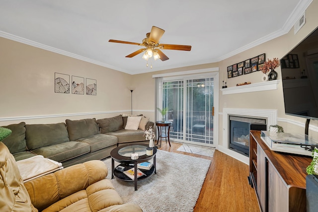 2003 Tall Oaks Dr Unit 2B, Aurora, IL 60505 - living area with light wood-type flooring, crown molding, ceiling fan, and a glass covered fireplace