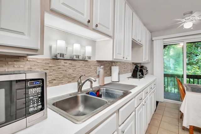 2003 Tall Oaks Dr Unit 2B, Aurora, IL 60505 - kitchen with stainless steel microwave, white cabinetry, and backsplash