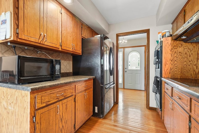 7340 Mimosa Dr, Orland Park, IL 60462 - kitchen with black appliances, ventilation hood, tasteful backsplash, and brown cabinetry