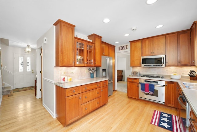 428 Linsey Ave, Schaumburg, IL 60194 - kitchen featuring stainless steel appliances, light wood finished floors, light countertops, tasteful backsplash, and recessed lighting