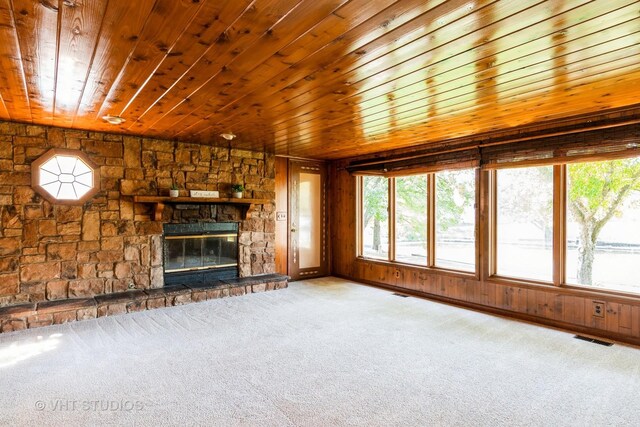 65 Old Post Rd, Montgomery, IL 60538 - unfurnished living room featuring wooden ceiling, carpet, and a fireplace