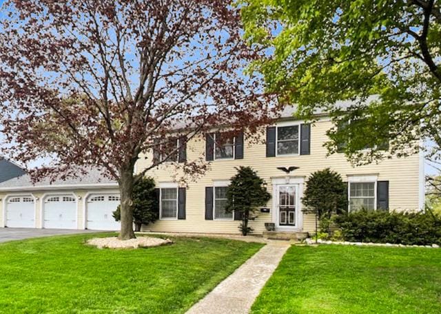 65 Old Post Rd, Montgomery, IL 60538 - view of front of property with a front yard, a garage, and driveway