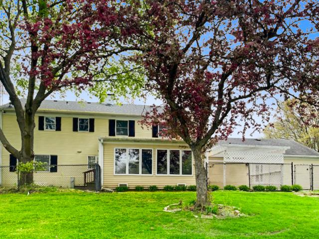 65 Old Post Rd, Montgomery, IL 60538 - rear view of house featuring an attached garage