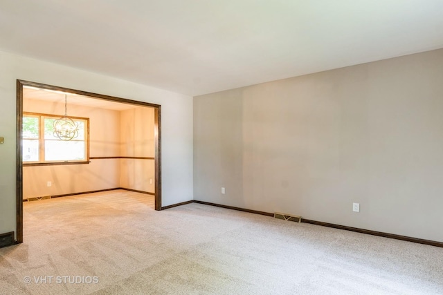 65 Old Post Rd, Montgomery, IL 60538 - spare room featuring light carpet and a chandelier