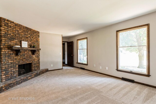 65 Old Post Rd, Montgomery, IL 60538 - unfurnished living room with carpet flooring and a fireplace