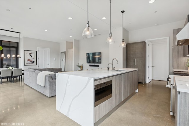 900 W Washington Blvd Unit 404, Chicago, IL 60607 - kitchen featuring modern cabinets, stove, wall chimney exhaust hood, a large island with sink, and open floor plan