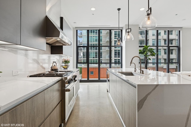 900 W Washington Blvd Unit 404, Chicago, IL 60607 - kitchen with stainless steel range, modern cabinets, expansive windows, wall chimney exhaust hood, and pendant lighting