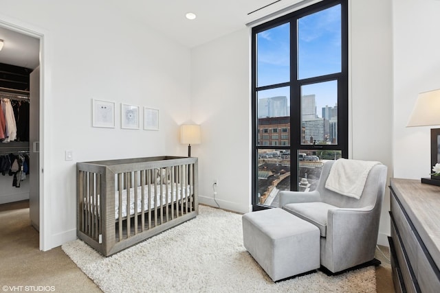 900 W Washington Blvd Unit 404, Chicago, IL 60607 - bedroom featuring a city view, carpet flooring, a spacious closet, and a nursery area
