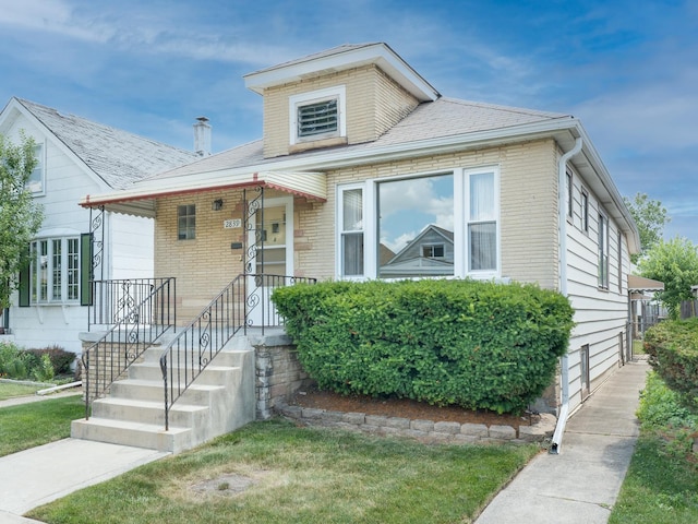 2839 N 75th Ct, Elmwood Park, IL 60707 - view of front of property with brick siding, a porch, and a front yard