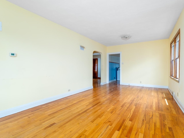 2839 N 75th Ct, Elmwood Park, IL 60707 - unfurnished room featuring arched walkways and light wood-style flooring