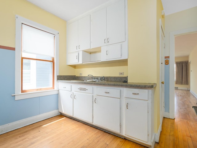 2839 N 75th Ct, Elmwood Park, IL 60707 - kitchen featuring white cabinetry, light wood-style floors, and dark countertops