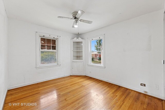 9205 S Utica Ave, Evergreen Park, IL 60805 - unfurnished room with light wood-style flooring and ceiling fan