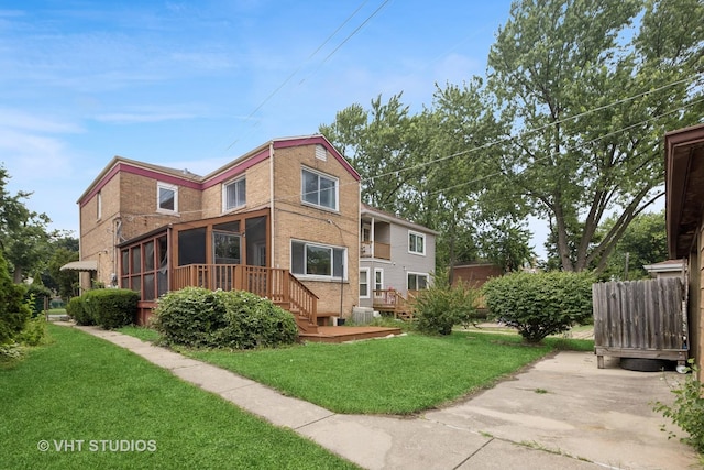9205 S Utica Ave, Evergreen Park, IL 60805 - rear view of property featuring brick siding, a sunroom, a yard, and a deck