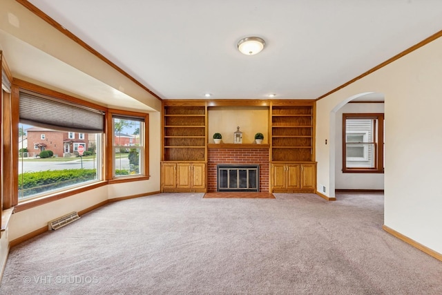 9205 S Utica Ave, Evergreen Park, IL 60805 - unfurnished living room with light colored carpet, ornamental molding, arched walkways, a fireplace, and built in features