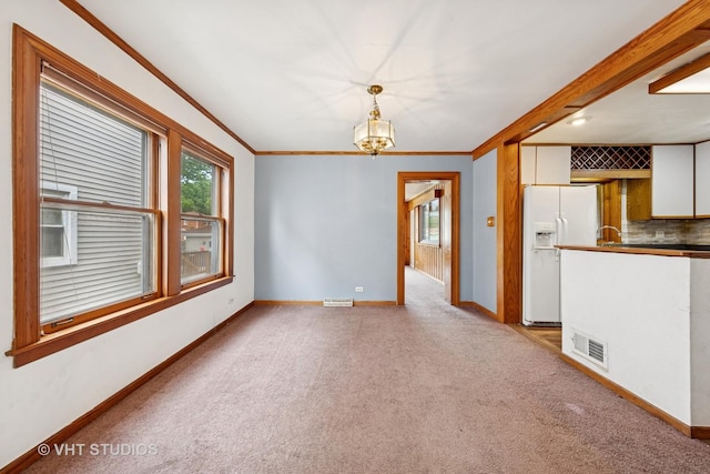 9205 S Utica Ave, Evergreen Park, IL 60805 - spare room featuring a chandelier, light carpet, and ornamental molding