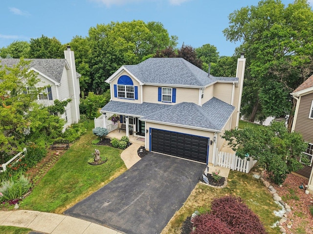 4203 Bunratty Ln, Plainfield, IL 60586 - traditional-style house featuring covered porch, roof with shingles, asphalt driveway, a chimney, and a garage