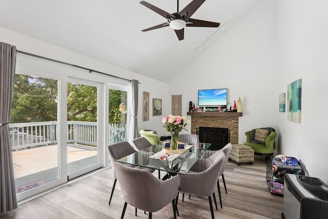 4203 Bunratty Ln, Plainfield, IL 60586 - dining space with high vaulted ceiling, wood finished floors, a stone fireplace, and a ceiling fan