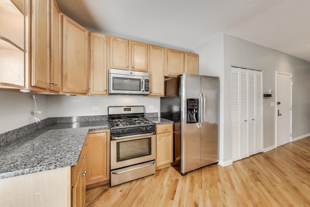 4653 N Lawndale Ave Unit 2S, Chicago, IL 60625 - kitchen featuring appliances with stainless steel finishes, light brown cabinetry, light wood-style floors, and dark stone counters