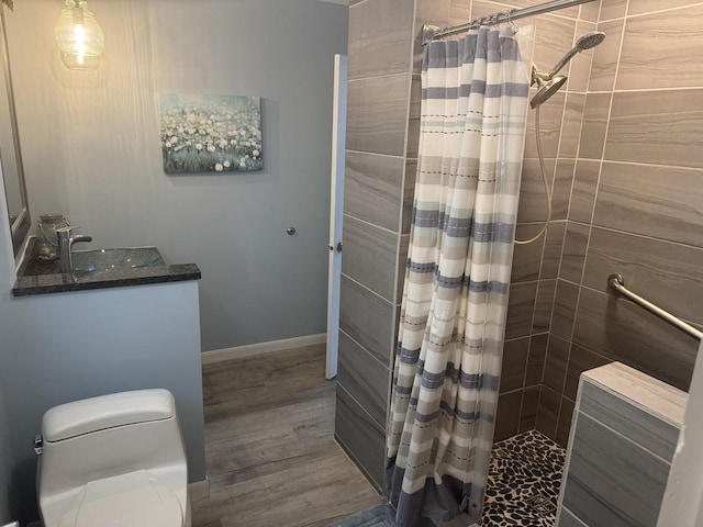 600 W White St, Clinton, IL 61727 - full bathroom featuring tiled shower, wood finished floors, and vanity
