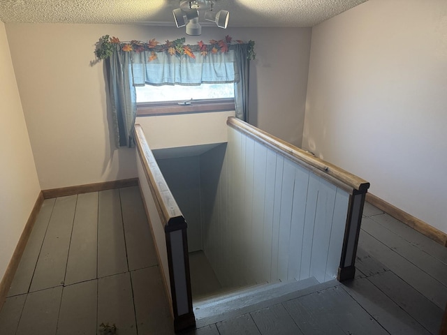 600 W White St, Clinton, IL 61727 - stairs featuring a textured ceiling and a wainscoted wall
