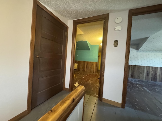 600 W White St, Clinton, IL 61727 - corridor with wooden walls, wallpapered walls, a textured ceiling, and a wainscoted wall