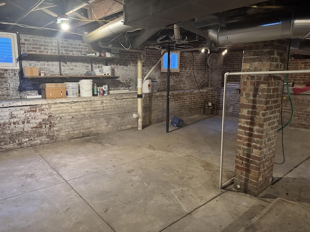 600 W White St, Clinton, IL 61727 - unfinished basement featuring brick wall