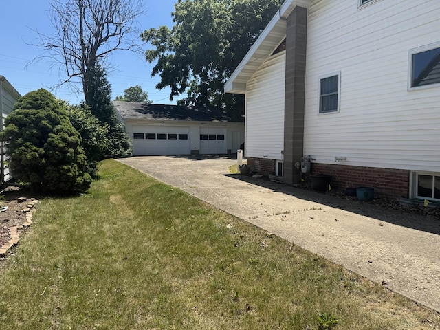 600 W White St, Clinton, IL 61727 - view of home's exterior featuring a lawn and a garage